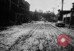 Image of rapid flowing water in streets United States USA, 1955, second 26 stock footage video 65675052615