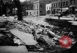 Image of rapid flowing water in streets United States USA, 1955, second 34 stock footage video 65675052615