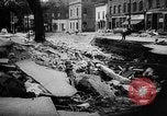 Image of rapid flowing water in streets United States USA, 1955, second 36 stock footage video 65675052615
