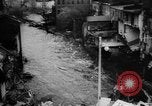 Image of rapid flowing water in streets United States USA, 1955, second 40 stock footage video 65675052615