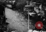 Image of rapid flowing water in streets United States USA, 1955, second 41 stock footage video 65675052615