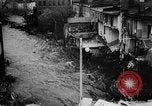 Image of rapid flowing water in streets United States USA, 1955, second 43 stock footage video 65675052615