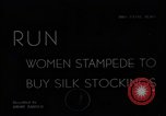 Image of women buying silk stockings during war ration United States USA, 1942, second 1 stock footage video 65675053064