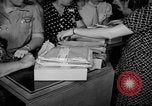 Image of women buying silk stockings during war ration United States USA, 1942, second 21 stock footage video 65675053064
