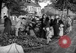 Image of Women pick up abandoned flowers London England United Kingdom, 1938, second 4 stock footage video 65675053799