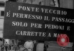 Image of Italian people crossing the war damaged Ponte Vecchio Bridge in Floren Florence Italy, 1945, second 3 stock footage video 65675053879