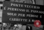 Image of Italian people crossing the war damaged Ponte Vecchio Bridge in Floren Florence Italy, 1945, second 4 stock footage video 65675053879