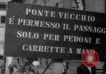 Image of Italian people crossing the war damaged Ponte Vecchio Bridge in Floren Florence Italy, 1945, second 5 stock footage video 65675053879