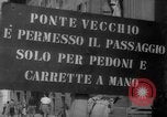 Image of Italian people crossing the war damaged Ponte Vecchio Bridge in Floren Florence Italy, 1945, second 6 stock footage video 65675053879