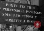 Image of Italian people crossing the war damaged Ponte Vecchio Bridge in Floren Florence Italy, 1945, second 7 stock footage video 65675053879