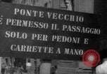 Image of Italian people crossing the war damaged Ponte Vecchio Bridge in Floren Florence Italy, 1945, second 9 stock footage video 65675053879