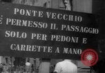 Image of Italian people crossing the war damaged Ponte Vecchio Bridge in Floren Florence Italy, 1945, second 10 stock footage video 65675053879