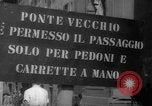 Image of Italian people crossing the war damaged Ponte Vecchio Bridge in Floren Florence Italy, 1945, second 12 stock footage video 65675053879