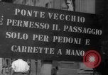 Image of Italian people crossing the war damaged Ponte Vecchio Bridge in Floren Florence Italy, 1945, second 13 stock footage video 65675053879