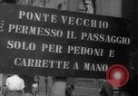 Image of Italian people crossing the war damaged Ponte Vecchio Bridge in Floren Florence Italy, 1945, second 14 stock footage video 65675053879