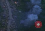 Image of huts attacked in bombing mission in Vietnam War Vietnam, 1965, second 48 stock footage video 65675054855