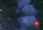 Image of huts attacked in bombing mission in Vietnam War Vietnam, 1965, second 54 stock footage video 65675054855