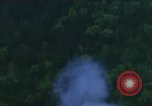 Image of huts attacked in bombing mission in Vietnam War Vietnam, 1965, second 56 stock footage video 65675054855