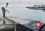 Image of man spreads grease on ways at Newport News Shipyard Newport News Virginia USA, 1943, second 1 stock footage video 65675055340