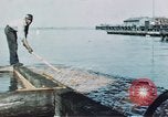 Image of man spreads grease on ways at Newport News Shipyard Newport News Virginia USA, 1943, second 3 stock footage video 65675055340