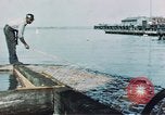 Image of man spreads grease on ways at Newport News Shipyard Newport News Virginia USA, 1943, second 4 stock footage video 65675055340