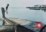 Image of man spreads grease on ways at Newport News Shipyard Newport News Virginia USA, 1943, second 8 stock footage video 65675055340