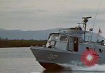 Image of explosions along riverbank Vietnam, 1966, second 11 stock footage video 65675055555