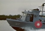 Image of explosions along riverbank Vietnam, 1966, second 13 stock footage video 65675055555