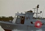 Image of explosions along riverbank Vietnam, 1966, second 14 stock footage video 65675055555