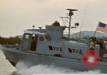 Image of explosions along riverbank Vietnam, 1966, second 16 stock footage video 65675055555