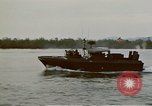 Image of explosions along riverbank Vietnam, 1966, second 19 stock footage video 65675055555