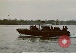Image of explosions along riverbank Vietnam, 1966, second 20 stock footage video 65675055555