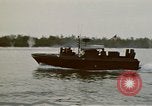 Image of explosions along riverbank Vietnam, 1966, second 21 stock footage video 65675055555