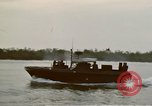 Image of explosions along riverbank Vietnam, 1966, second 22 stock footage video 65675055555