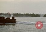 Image of explosions along riverbank Vietnam, 1966, second 24 stock footage video 65675055555