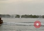 Image of explosions along riverbank Vietnam, 1966, second 25 stock footage video 65675055555