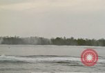 Image of explosions along riverbank Vietnam, 1966, second 26 stock footage video 65675055555