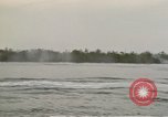 Image of explosions along riverbank Vietnam, 1966, second 27 stock footage video 65675055555