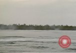 Image of explosions along riverbank Vietnam, 1966, second 28 stock footage video 65675055555