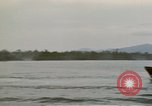 Image of explosions along riverbank Vietnam, 1966, second 29 stock footage video 65675055555