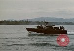 Image of explosions along riverbank Vietnam, 1966, second 30 stock footage video 65675055555