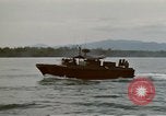 Image of explosions along riverbank Vietnam, 1966, second 31 stock footage video 65675055555