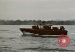 Image of explosions along riverbank Vietnam, 1966, second 33 stock footage video 65675055555