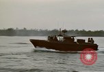 Image of explosions along riverbank Vietnam, 1966, second 34 stock footage video 65675055555