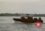Image of explosions along riverbank Vietnam, 1966, second 35 stock footage video 65675055555