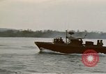 Image of explosions along riverbank Vietnam, 1966, second 36 stock footage video 65675055555