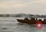 Image of explosions along riverbank Vietnam, 1966, second 38 stock footage video 65675055555