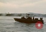 Image of explosions along riverbank Vietnam, 1966, second 39 stock footage video 65675055555