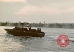 Image of explosions along riverbank Vietnam, 1966, second 42 stock footage video 65675055555