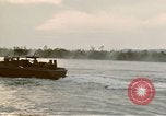 Image of explosions along riverbank Vietnam, 1966, second 43 stock footage video 65675055555